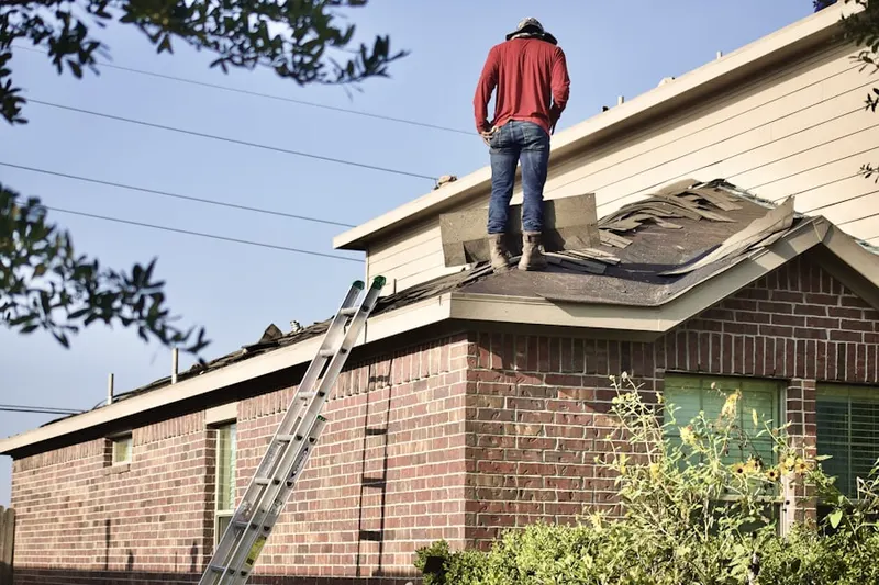 Professional roofer working on a residential roof in College Park Woods